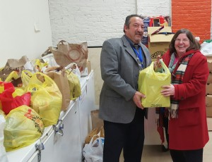 Robert Mauriello (left), Director of Operations and Parish Cemetery Liaison at Catholic Cemeteries of the Archdiocese of Newark, proudly presented approximately 120 bags (nearly 1,000 pounds) of non-perishable food and a check for $1,000 to Sharon Reilly-Tobin (right), Program Manager for the Emergency Food Network of Catholic Charities in East Orange, New Jersey.